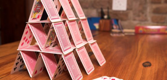House of cards on a wooden table (very shallow Depth of Field)